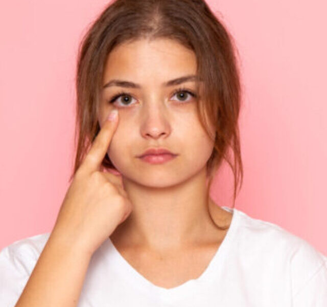 front-view-young-beautiful-female-white-shirt-showing-her-eye